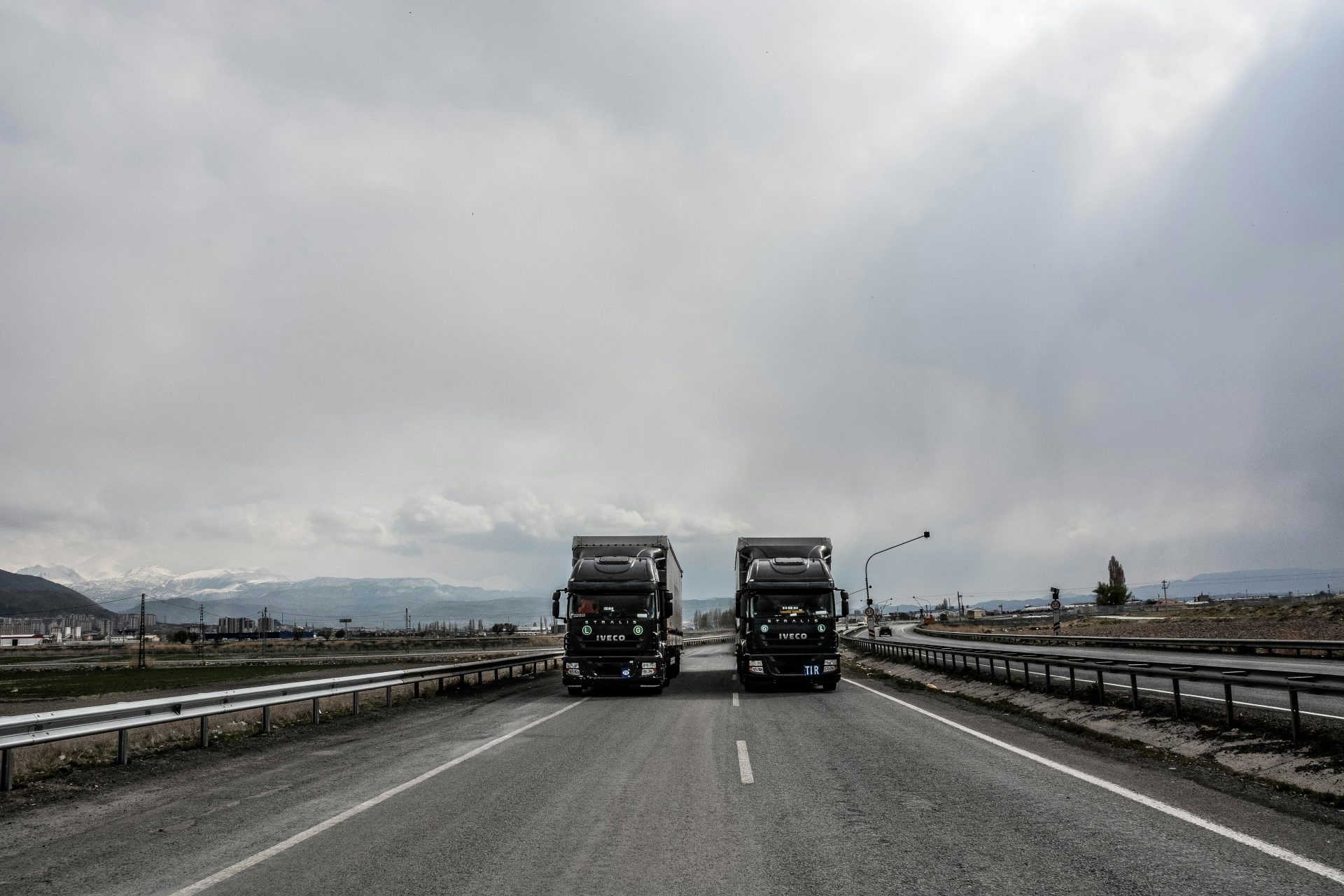 blue and white truck on road during daytime